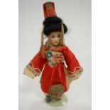 A Simon & Halbig Oriental bisque head doll, having black wig, fixed brown eyes with painted brows