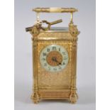 A circa 1900 French lacquered brass carriage clock, the fancy case having four fluted three-