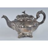 A William IV silver teapot, of fluted melon form with acanthus leaf decoration and flower head