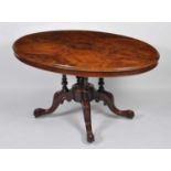 A Victorian figured walnut pedestal loo table, having a four-quarter veneered oval tilt-top, to a