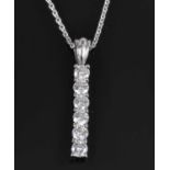A contemporary 18ct white gold bar pendant, set with seven brilliant cut diamonds, fitted to an 18ct