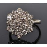 An 18ct white gold diamond circular cluster ring, featuring 19 round brilliant cut diamonds in