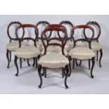 A set of four Victorian mahogany balloon back dining chairs, each having silk damask stuffover seats