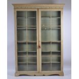 A Regency period and later polychrome painted bookcase, of good size, having twin glazed doors