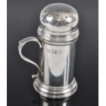 An Edwardian Britannia silver salt shaker, with removable pierced cover and S-scroll handle, maker