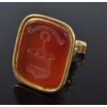 A late Georgian yellow metal carnelian seal fob pendant, the intaglio carved with a coat of arms and