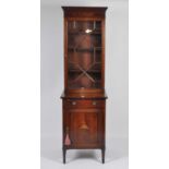A Sheraton Revival mahogany and inlaid cabinet, of narrow proportions, the upper section with