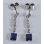 A pair of white metal Art Deco style sapphire and diamond earrings, each comprising a rectangular