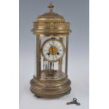 An early 20th century French gilt metal four-glass cylindrical mantel clock, having anthemion leaf