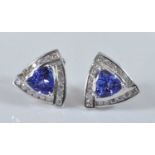 A pair of white metal, tanzanite and diamond triangular cluster earrings, each comprising a