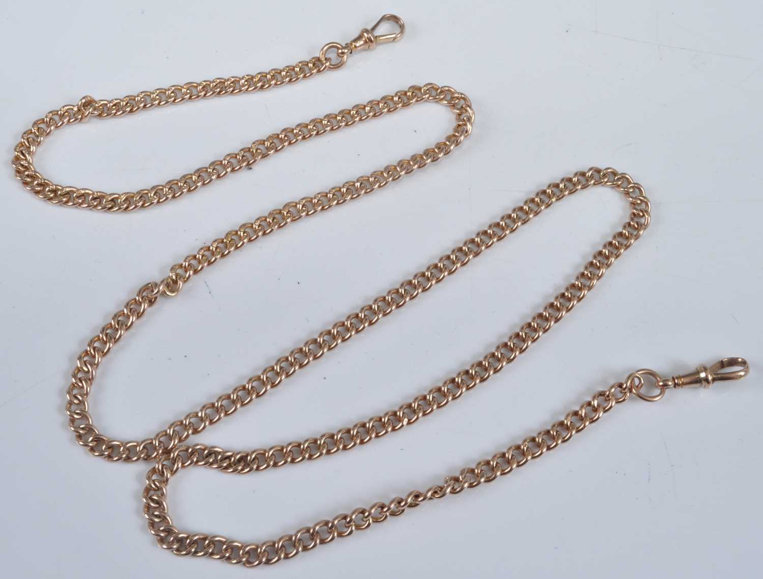 A 9ct gold curblink long watch chain, with twin fastenings, 42.6g, w.4.5mm, length 76cm
