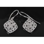 A pair of white metal diamond off-square openwork cluster earrings, each with 93 round brilliant cut