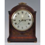 An early 19th century mahogany bracket clock, having an unsigned convex white enamel Roman dial,