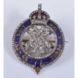 A yellow and white metal diamond set Queen Alexandra commemorative brooch, featuring a centre triple