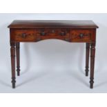 A William IV mahogany side table, having three frieze drawers and raised on tulip carved ring turned