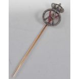 A yellow metal Royal monogram stick pin, comprising the initials VA within an orb surround set