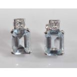 A pair of 18ct white gold, aquamarine and diamond ear studs, each comprising a rectangular cut