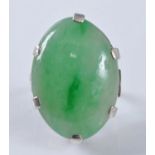 A white metal jadeite dress ring, featuring an oval jadeite cabochon in a six claw setting,