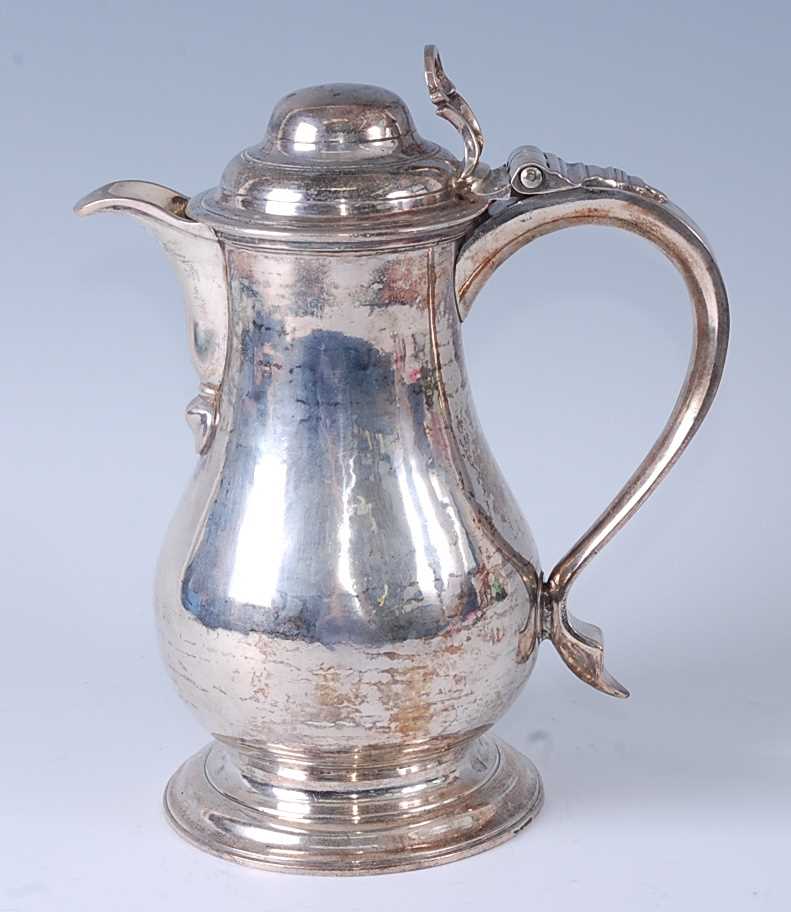 An early George III silver wine or beer jug, having a hinged domed cover, S-scroll handle, and - Image 3 of 6