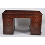 A Victorian walnut twin pedestal desk, having a gilt tooled brown leather inset writing surface