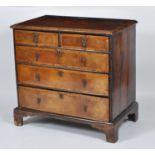 An early 18th century walnut and inlaid chest, having crossbanded top over two short and three