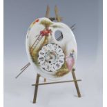 A late 19th century French easel clock, the ceramic dial in the form of an artists palette decorated