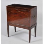 A Sheraton period mahogany, rosewood crossbanded and inlaid wine cooler, the hinged cover opening to