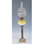 A Victorian brass oil lamp, having an acid etched glass shade and anthemion moulded yellow tinted