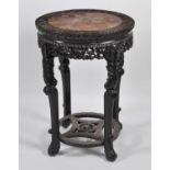 A Chinese 'rosewood' and marble topped occasional table, of circular form, with all-over leaf and