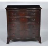 A mahogany serpentine front chest in the Georgian style, mid-20th century, having a brushing slide