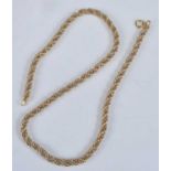 A contemporary heavy yellow metal ropetwist necklace, intertwined with smaller white metal chain
