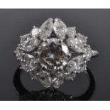 A Boucheron platinum and diamond oblong cluster ring, featuring a centre round brilliant cut diamond
