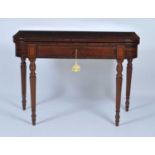 An early 19th century mahogany tea table, having a boxwood and ebony strung crossbanded fold-over