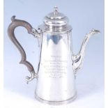 An Edwardian silver coffee pot of tapered conical form, having a hinged domed cover with acorn