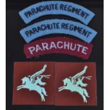 A pair of Partachute Regiment cloth shoulder titles, each with black lettering on a blue backing,