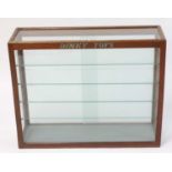 An original 1950s Dinky Toys oak and glazed shop display cabinet comprising of rear sliding doors