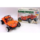 A Tamiya 1/10 scale radio controlled model of a Sand Rover off-road car, comprising fluorescent