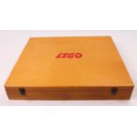 A Lego 1970s/80s wooden storage box containing a collection of various Lego components, with a