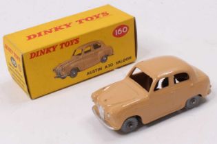 Dinky Toys No. 160 Austin A30 saloon, comprising tan body with grey plastic wheels housed in the