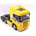 A Tamiya plastic and radio controlled kit built model of a Scania R620 6x4 tractor unit decorated in