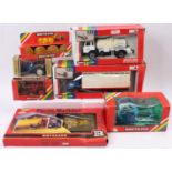 Seven various boxed Britains farming vehicles and accessories all in original window and card