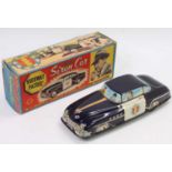 A Welsotoys tin plate and friction drive model of a Police Highway patrol car, finished in black and