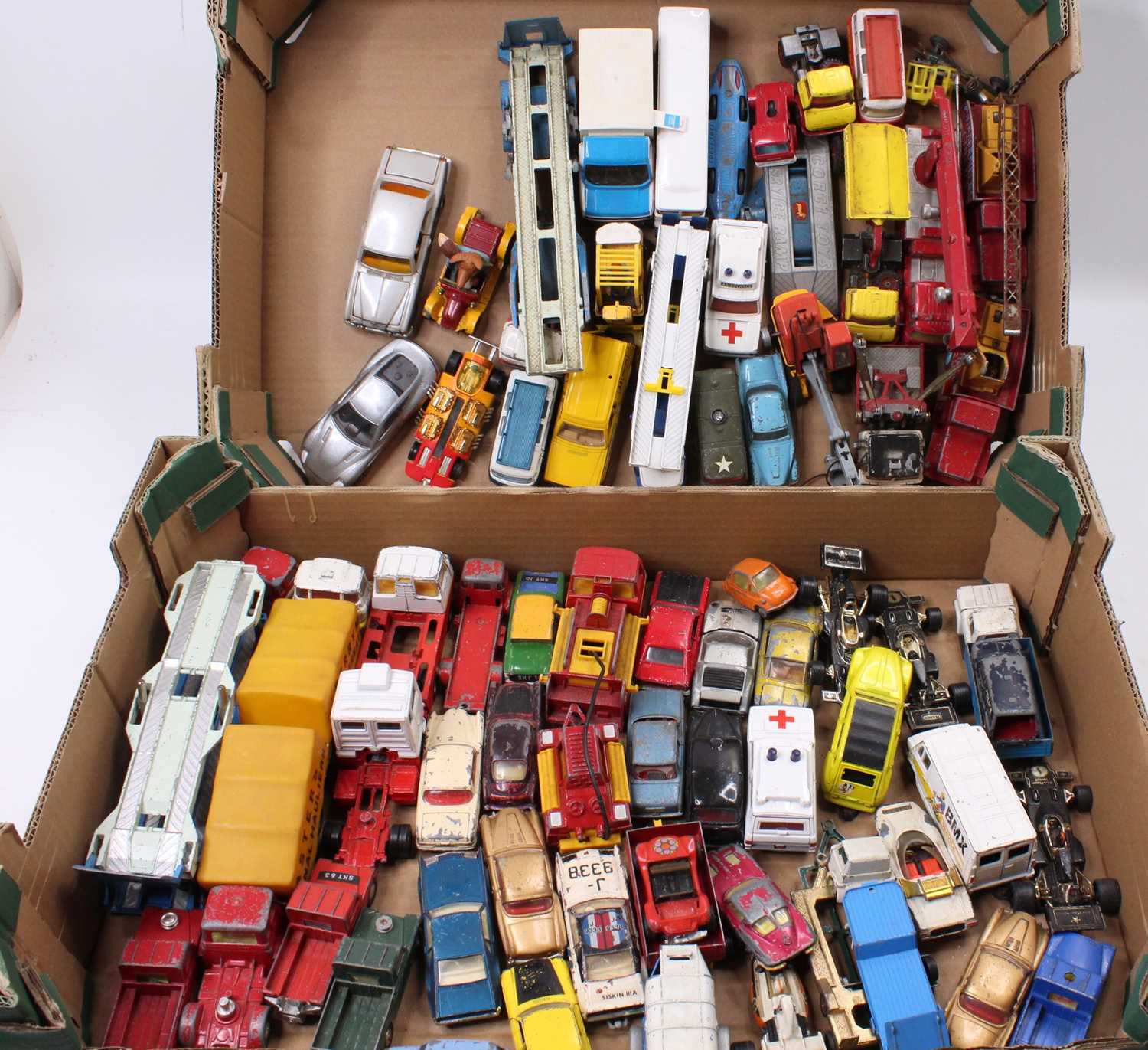 Two trays containing a large quantity of Corgi Toys vehicles in play worn condition to include,