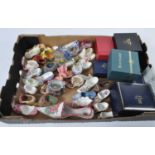 A box of miniature shoes, to include porcelain and resin examples