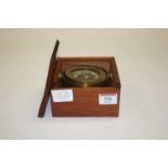 A reproduction brass ships compass, housed within a teak box, dia.9cm