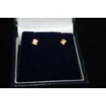 A pair of 14ct yellow gold diamond set ear studs, the illusion set round brilliants each weighing