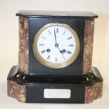 A Victorian black slate and rouge marble eight-day mantel clock, the enamelled dial showing Roman