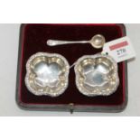 A pair of sterling silver table salts, each of quatrefoil form, w.16cm (lacking one spoon), boxed,