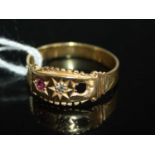 A yellow metal, ruby and diamond dress ring, unmarked but tests as 18ct gold, having single small '