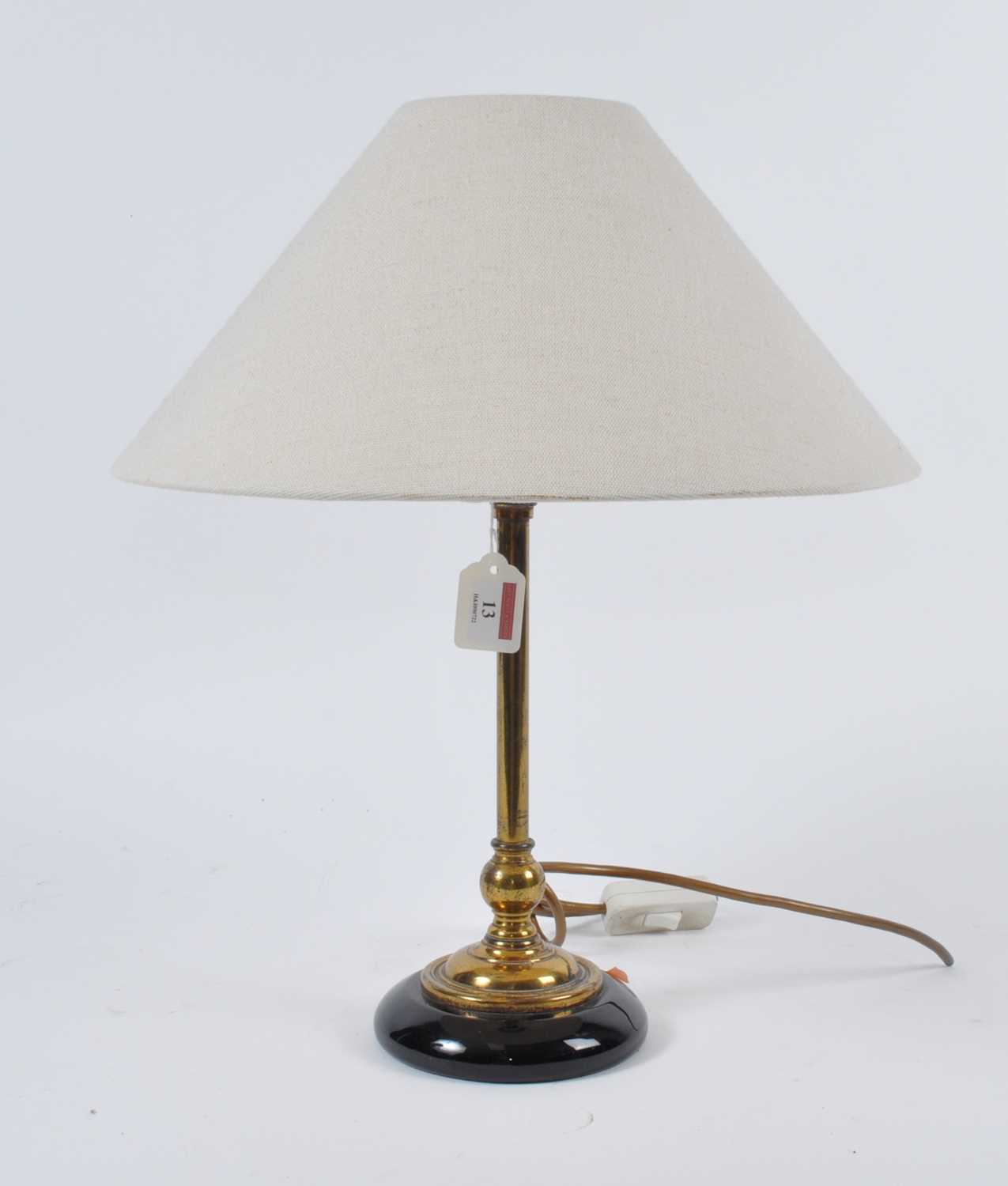 A 20th century brass table lamp, having cream shade, h.46cm